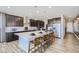 Spacious kitchen with a large center island, sleek dark cabinetry, and modern appliances, perfect for cooking at 1320 Loraine N Cir, Lafayette, CO 80026