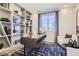 Stylish home office with built-in shelving, a modern desk, and a comfortable seating area, perfect for work at 1320 Loraine N Cir, Lafayette, CO 80026