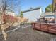 Backyard with a raised wooden deck and space for gardening at 10443 W 84Th Pl, Arvada, CO 80005