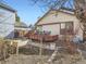 Backyard with wooden deck and brick features for garden beds at 10443 W 84Th Pl, Arvada, CO 80005