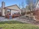 Backyard and deck area surrounded by greenery and a lawn at 10443 W 84Th Pl, Arvada, CO 80005