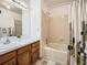 Bathroom featuring a shower and a wooden vanity at 10443 W 84Th Pl, Arvada, CO 80005