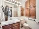 Bathroom featuring a shower, wooden vanity, and a large mirror at 10443 W 84Th Pl, Arvada, CO 80005