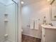 Clean bathroom with a shower, vanity, mirror, and tile floors at 10443 W 84Th Pl, Arvada, CO 80005