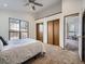 Spacious bedroom with plush carpet and view through a big window at 10443 W 84Th Pl, Arvada, CO 80005