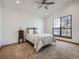 Bedroom with plush carpet, vaulted ceiling, and a bright window with a view at 10443 W 84Th Pl, Arvada, CO 80005