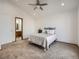 Bright bedroom featuring plush carpet and adjacent to a bathroom with a wooden vanity at 10443 W 84Th Pl, Arvada, CO 80005