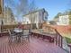 Outdoor deck area with a dining table and seating for enjoying meals at 10443 W 84Th Pl, Arvada, CO 80005