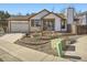 Charming home features a well-manicured front yard and a two-car garage, enhancing curb appeal and functionality at 10443 W 84Th Pl, Arvada, CO 80005