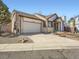 Charming home with a two-car garage and a well-maintained lawn, showcasing its inviting curb appeal at 10443 W 84Th Pl, Arvada, CO 80005