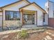 Close up of home's inviting front porch and entry features a charming setup, enhancing its welcoming curb appeal at 10443 W 84Th Pl, Arvada, CO 80005