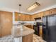 Well-maintained kitchen featuring ample cabinet storage and a breakfast bar, perfect for casual dining at 10443 W 84Th Pl, Arvada, CO 80005