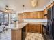 Functional kitchen with ample cabinet space, a convenient breakfast bar, and adjacent dining area for easy entertaining at 10443 W 84Th Pl, Arvada, CO 80005