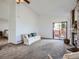 Bright living room featuring a brick fireplace, sliding glass door, and neutral decor for a comfortable feel at 10443 W 84Th Pl, Arvada, CO 80005