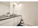 Double vanity bathroom with dark countertop and white cabinets at 677 Brookwood Dr, Lafayette, CO 80026