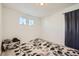 Bright bedroom with two windows and gray carpet at 677 Brookwood Dr, Lafayette, CO 80026