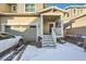 Tan two-story townhome with attached garage and front porch at 677 Brookwood Dr, Lafayette, CO 80026