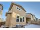 Tan siding house exterior with windows and snowy yard at 677 Brookwood Dr, Lafayette, CO 80026