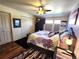 Comfortable bedroom with hardwood floors, closet space and ceiling fan at 13474 W 65Th Dr, Arvada, CO 80004