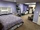 Bedroom with purple walls, additional seating area, and desk at 13474 W 65Th Dr, Arvada, CO 80004