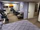 Bedroom featuring a large bed, desk area, and an exercise machine at 13474 W 65Th Dr, Arvada, CO 80004