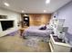 Spacious bedroom featuring wood accent wall and built in storage at 13474 W 65Th Dr, Arvada, CO 80004