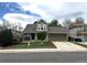 Charming two-story home with manicured lawn, mature trees, and a welcoming front porch at 13474 W 65Th Dr, Arvada, CO 80004