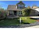Charming two-story home with landscaped yard, front patio, and inviting curb appeal at 13474 W 65Th Dr, Arvada, CO 80004