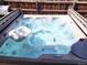 Hot tub with blue bubbling water and a drink holder floating for ultimate relaxation at 13474 W 65Th Dr, Arvada, CO 80004