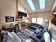Bright living room boasts vaulted ceilings with skylights and a cozy fireplace, perfect for relaxation and entertaining at 13474 W 65Th Dr, Arvada, CO 80004