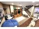 Basement living room area with wood stairs, a brown sofa, and comfortable seating at 13474 W 65Th Dr, Arvada, CO 80004