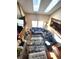 Cozy living room featuring skylights, a fireplace, and comfortable seating at 13474 W 65Th Dr, Arvada, CO 80004