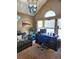 Bright home office with vaulted ceiling, arched window, dark desk and coastal-themed decor at 13474 W 65Th Dr, Arvada, CO 80004