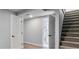 Finished basement area with newly painted walls, carpeted stairs, and access to a full bathroom at 1705 S Yuma St, Denver, CO 80223