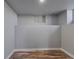 Unfinished basement featuring laminate flooring, freshly painted walls, and ample space for customization at 1705 S Yuma St, Denver, CO 80223