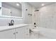 Modern bathroom with sleek fixtures, elegant tile work, and a luxurious shower-tub combination at 1705 S Yuma St, Denver, CO 80223