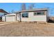 Charming single-story home with white siding, dark trim, and an attached garage at 1705 S Yuma St, Denver, CO 80223