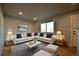 Bright living room featuring a stylish L-shaped sofa, modern decor, and large windows for natural light at 1705 S Yuma St, Denver, CO 80223