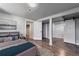 A serene main bedroom features neutral tones, a cozy bed, and access to ample closet space with sliding doors at 1705 S Yuma St, Denver, CO 80223