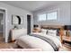 A cozy main bedroom with modern decor, neutral colors, and a serene atmosphere for relaxation at 1705 S Yuma St, Denver, CO 80223