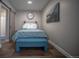 Simple bedroom with a teal bench and barn door leading to the bathroom at 408 Soda Creek Rd, Idaho Springs, CO 80452