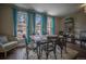 Rustic farmhouse dining area with large windows and seating for six at 408 Soda Creek Rd, Idaho Springs, CO 80452