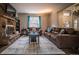 Cozy living room featuring a stone fireplace and comfy seating at 408 Soda Creek Rd, Idaho Springs, CO 80452