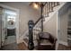 Elegant staircase with dark wood and a leather chair at 408 Soda Creek Rd, Idaho Springs, CO 80452