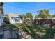 Fenced backyard featuring grass and a large shed, offering privacy and storage at 2862 S Grant St, Englewood, CO 80113