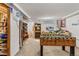 Spacious basement features a foosball table, bookshelves, and a unique Ford-branded wall clock at 2862 S Grant St, Englewood, CO 80113