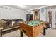 Basement featuring a foosball table, bed, and a storage safe, creating a versatile recreation area at 2862 S Grant St, Englewood, CO 80113