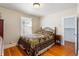 Cozy bedroom with hardwood floors, a comfortable bed, and a window providing natural light at 2862 S Grant St, Englewood, CO 80113