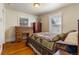 Charming bedroom with hardwood floors features a bed, window, wardrobe, and desk, creating a cozy and functional space at 2862 S Grant St, Englewood, CO 80113