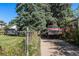 Long driveway leading up to the property, with mature trees and a vintage truck at 2862 S Grant St, Englewood, CO 80113